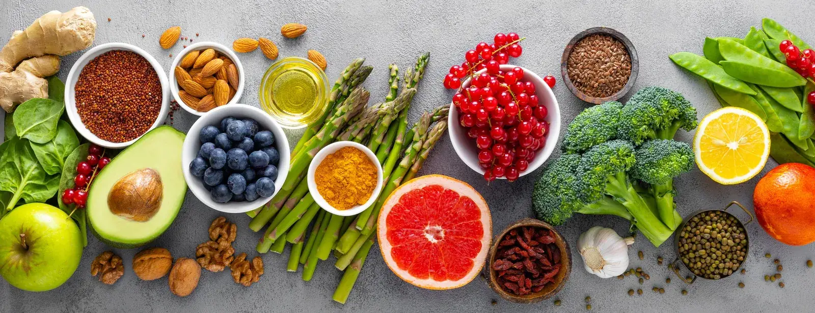 Healthy eating ingredients including broccoli, asparagus, citrus and seeds for a nutrition plan