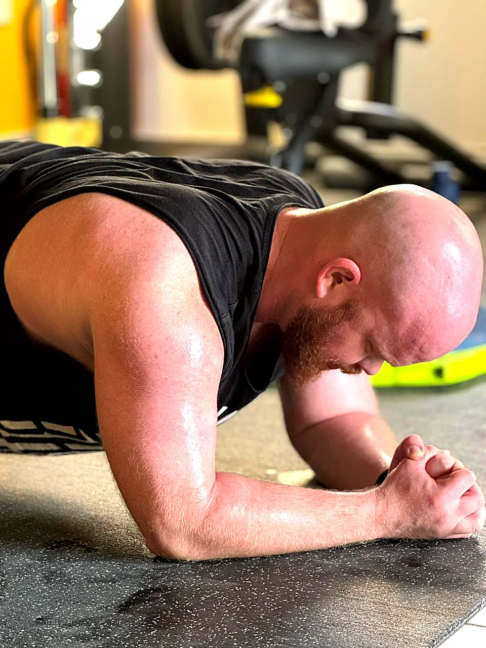 Man holding a forearm plank during core training at a gym in Peyia, Paphos